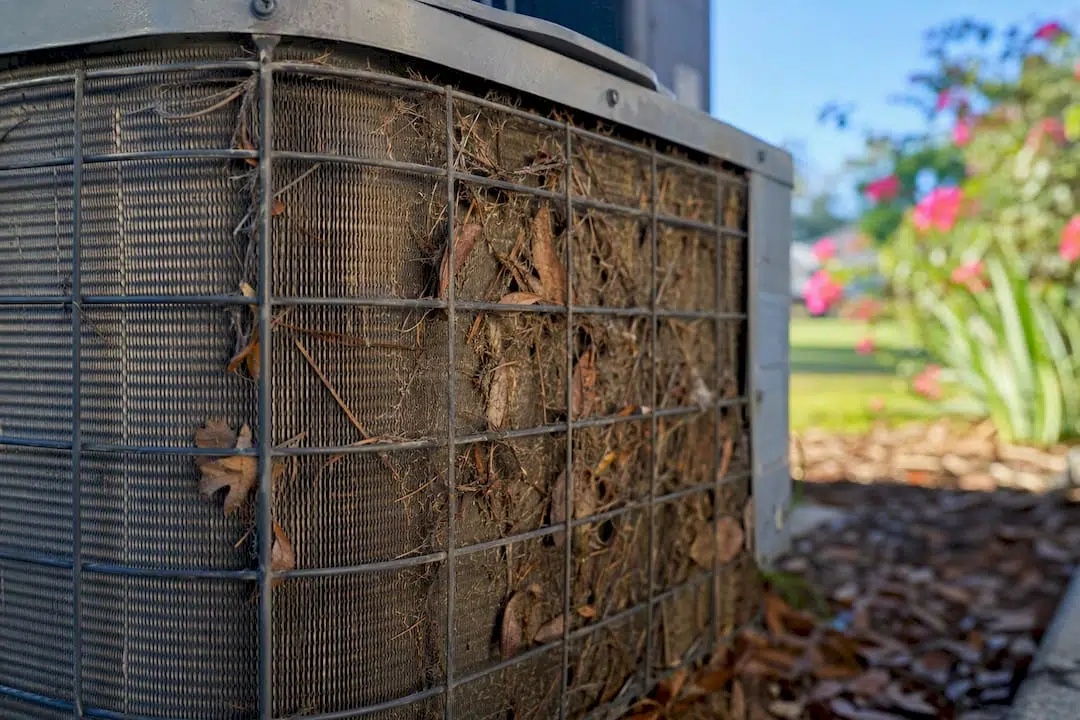Close-up of blocked condenser coil with debris