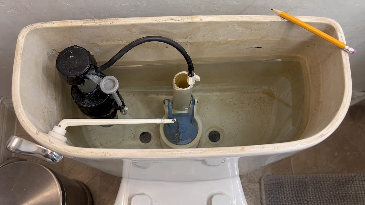 Pencil mark indicating the toilet tank waterline