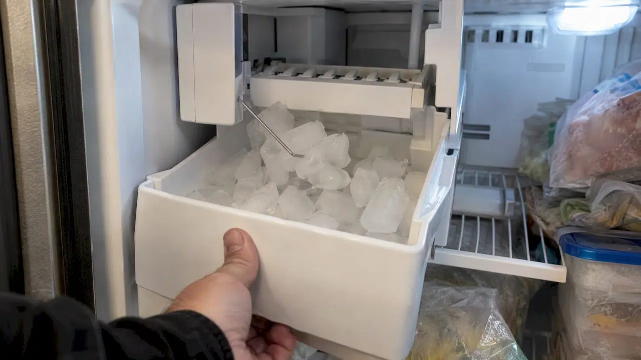 Clumped ice obstructing the freezer feeler arm